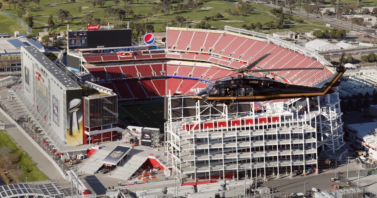 Levi's Stadium in Santa Clara, California An aerial view of Levi's Stadium in Santa Clara, California, showing its open bowl of red seats around a green field with the Levi's Stadium sign on the press box. A helicopter passes in front of the multi-level stadium.