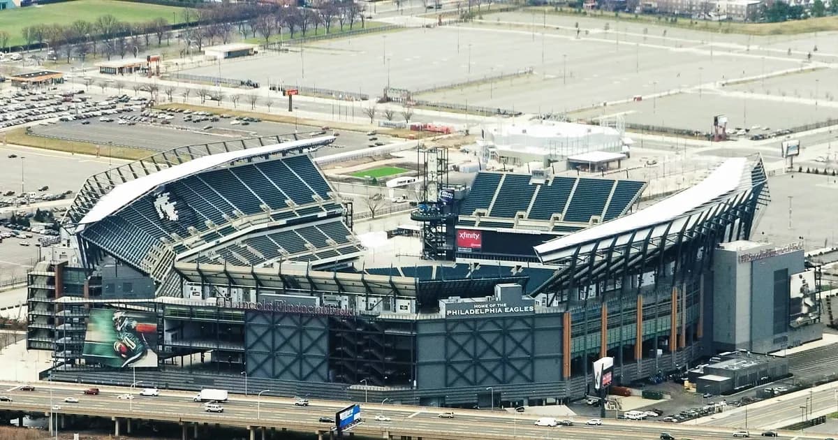 Lincoln Financial Field in Philadelphia An aerial view of Lincoln Financial Field in Philadelphia, its open seating bowl wrapping a green football field, with Home of the Philadelphia Eagles on the stand. Parking lots and a rail yard stretch out around the stadium.